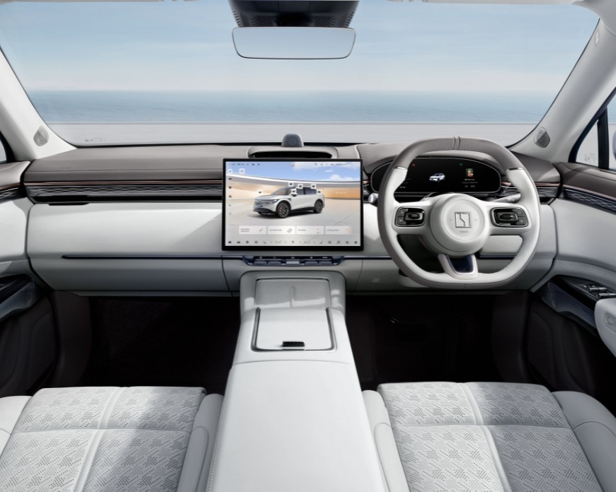 Right hand drive interior of a Zeekr showing the steering wheel and centre screen